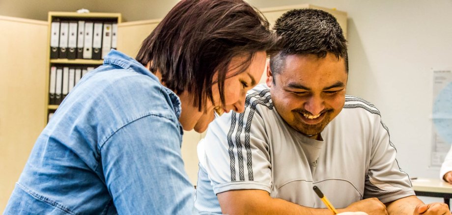 Case worker refugee office talks to a client