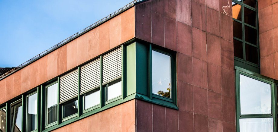 Detail view red building with green windows