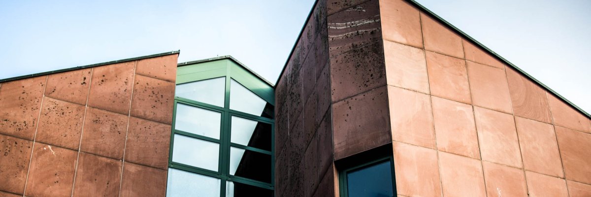 Detail view red building with green windows