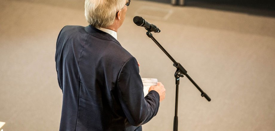 Back view of a man at the microphone