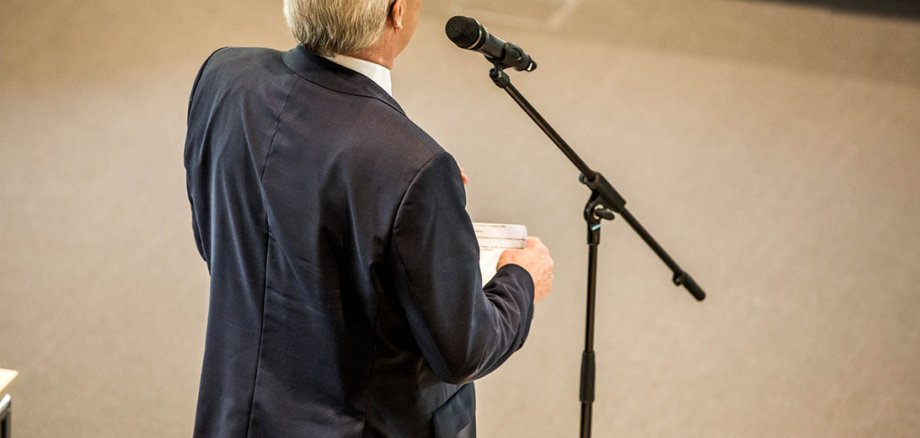Back view of a man at the microphone