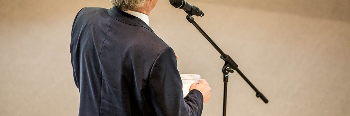 Back view of a man at the microphone