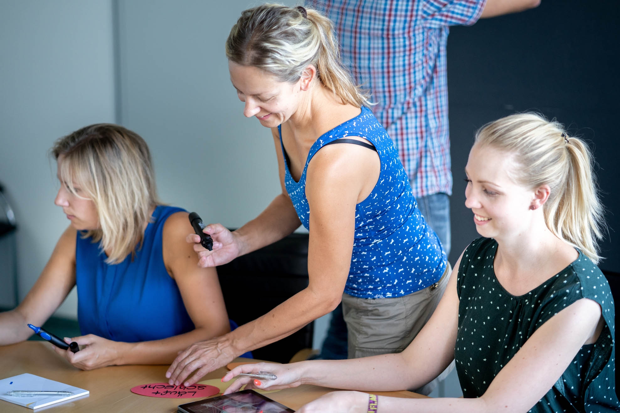 Three young women talking at a table