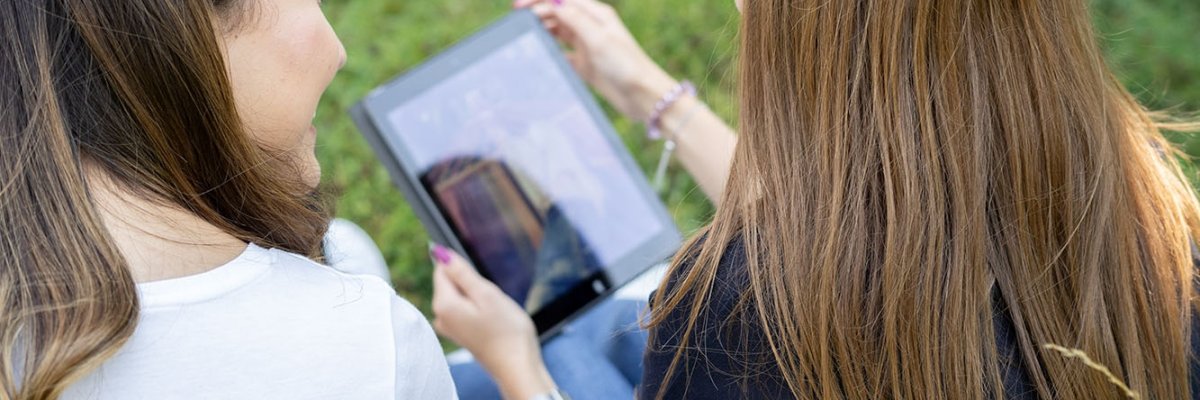 Two girls looking at a tablet