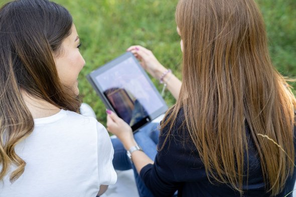 Digitisation Two girls looking at a tablet