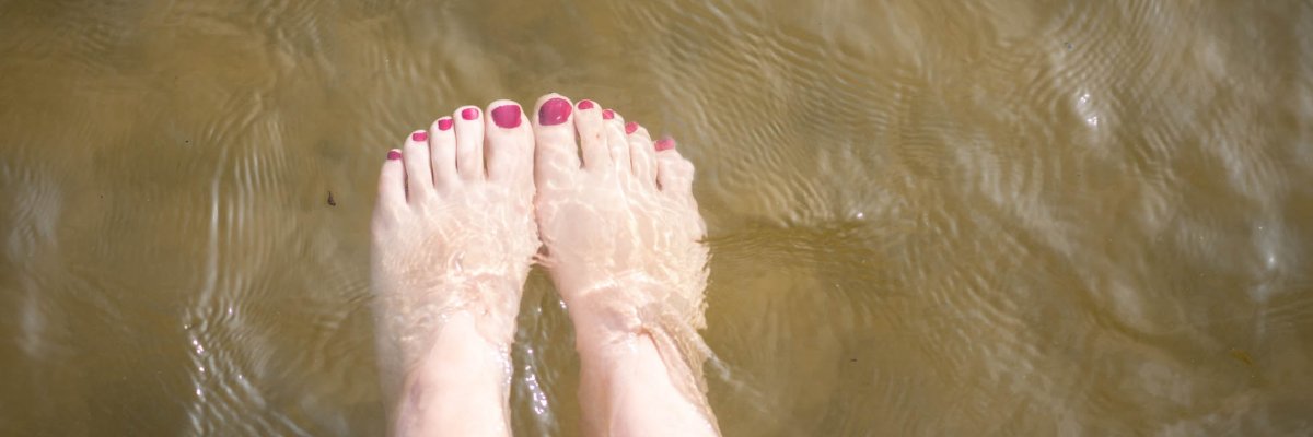 Bare feet over an expanse of water