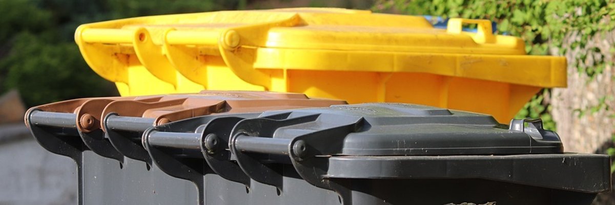 Two grey bins and one yellow bin.