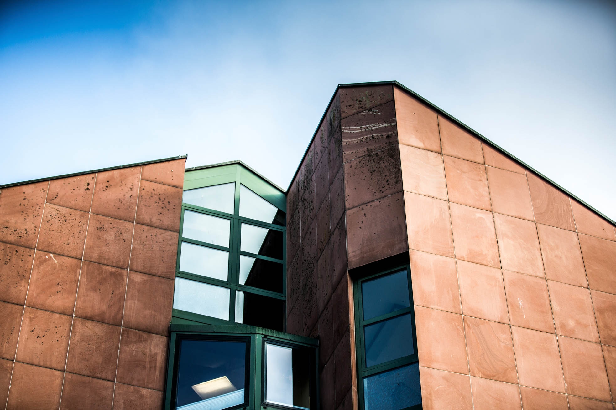 Detailansicht rotes Gebäude mit grünen Fenstern