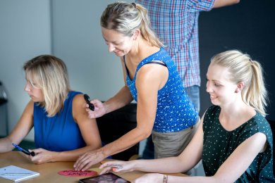 Workshop Seminar Drei junge Frauen im Gespräch an einem Tisch